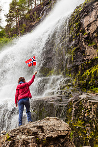 福伦达挪威的斯万达尔斯福森挪威的旅游妇女,挪威山区的强大瀑布旅游Ryfylke路线挪威瀑布svandalsfosse背景