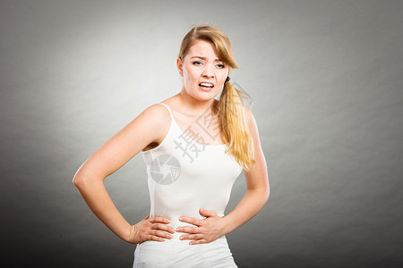 保健腹痛,消化良月经轻的女患强烈的胃痛,腹痛呈灰色女人患腹痛背景图片