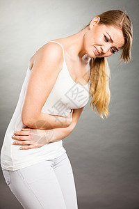 保健腹痛,消化良月经轻的女患强烈的胃痛,腹痛呈灰色女人患腹痛背景图片