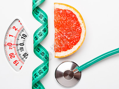 饮食健康饮食控制体重的柚子带测量带听诊器白色鳞片上图片