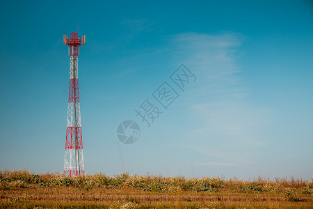 白色红色信号塔映衬着晴朗的蓝天工业自然比信号塔抗蓝天背景