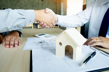 在签署合同后办公桌与客户握手图片