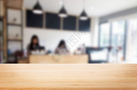 棕色木桌和咖啡店背景模糊带有bokeh图像用于相片补装或产品显示背景图片