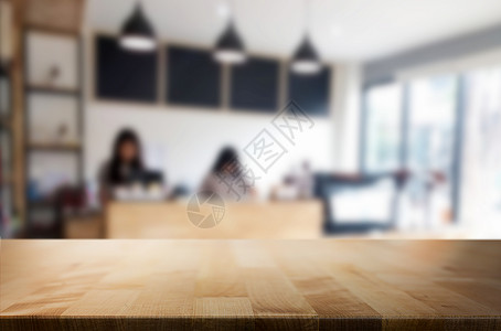 棕色木桌和咖啡店背景模糊带有bokeh图像用于相片补装或产品显示背景图片