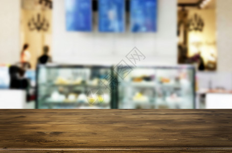 棕色木制桌和咖啡店或restaun模糊背景带有bokeh图像用于相片补装或产品显示背景图片