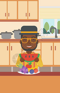 可食用在厨房里吃西瓜的男人设计图片