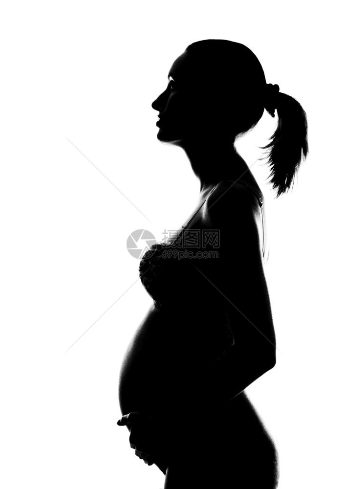 赤裸身的怀孕妇女抱腹部的轮廓图片