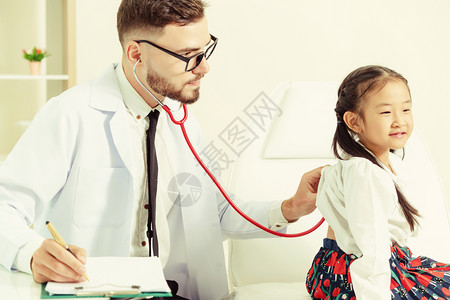 年轻男医生在院办公室检查小孩子不怕医生图片