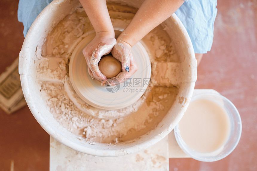 制作陶器轮的锅制作碗妇女手工制作的陶瓷艺品用粘土制成的餐具作陶器轮的锅女制作轮的图片