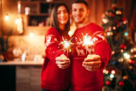 夫妻手握浪漫烟花一起庆祝圣诞图片