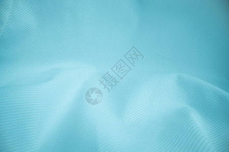 丝印光亮的流布纹理在宏观镜头中卷状的清洁丝绸织物纺抽象背景背景
