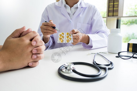医生持有药片向病人解释图片