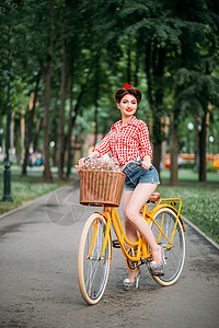 旧式自行车的女孩带鲜花背景图片
