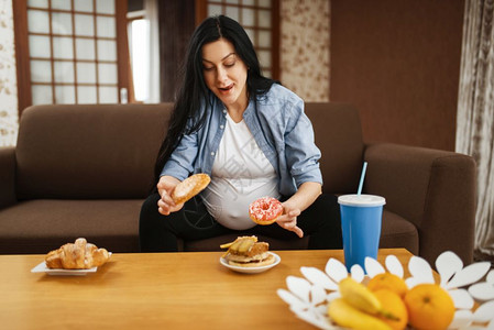 孕妇在起居室休息吃零食图片