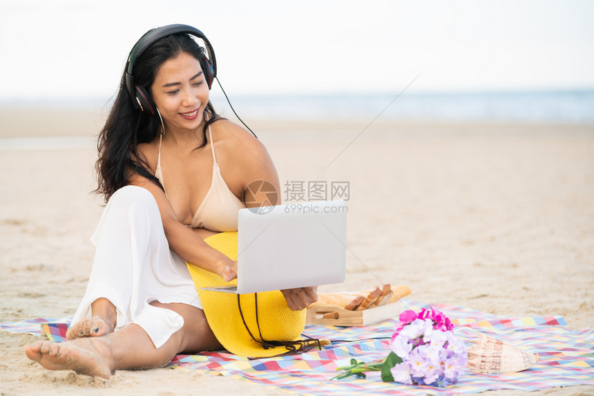 坐在海滩的年轻女子图片