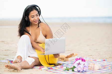 坐在海滩的年轻女子图片