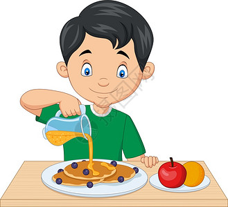 蓝莓煎饼上的小男孩流着红桃糖浆的蓝莓煎饼上背景图片