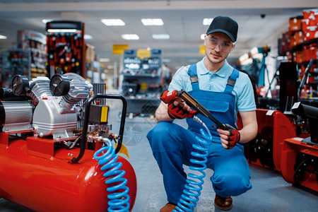 射钉在工具商店选择硬件仪器超市的专业设备工人在具商店中选择充气钉子背景