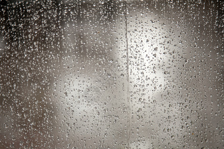 维拉尔下坡期间满是雨滴的潮湿窗口背景