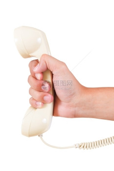 逆向旋转老旧电话和白色背景上的手图片