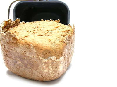 从面包机里拿出的地壳全谷物面包图片