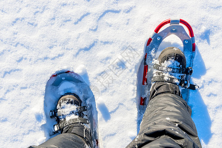 男人的腿被雪上鞋踩在图片