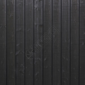 由建筑木制部分的垂直黑色木板构成的背景图片