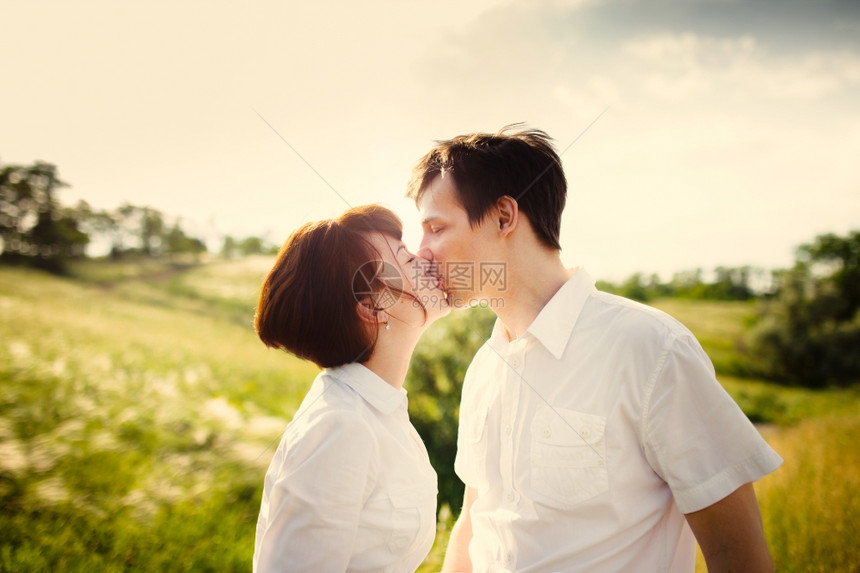 情侣在夏天的田野间接吻图片