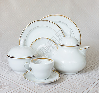 茶叶壶杯子餐盘甜食碗和美丽的桌布上糖碗背景图片