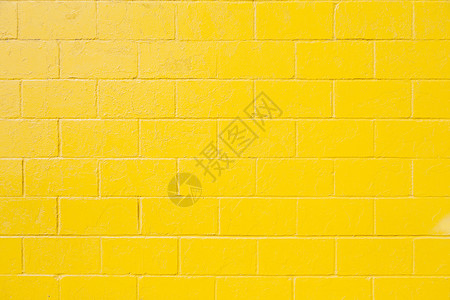 亮黄色油漆砖块墙水平部分背景图片