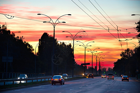 道路上行驶的汽车和日落图片