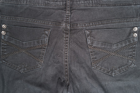 黑色牛仔裤口袋纹理背景带有复制空间的顶视图图片