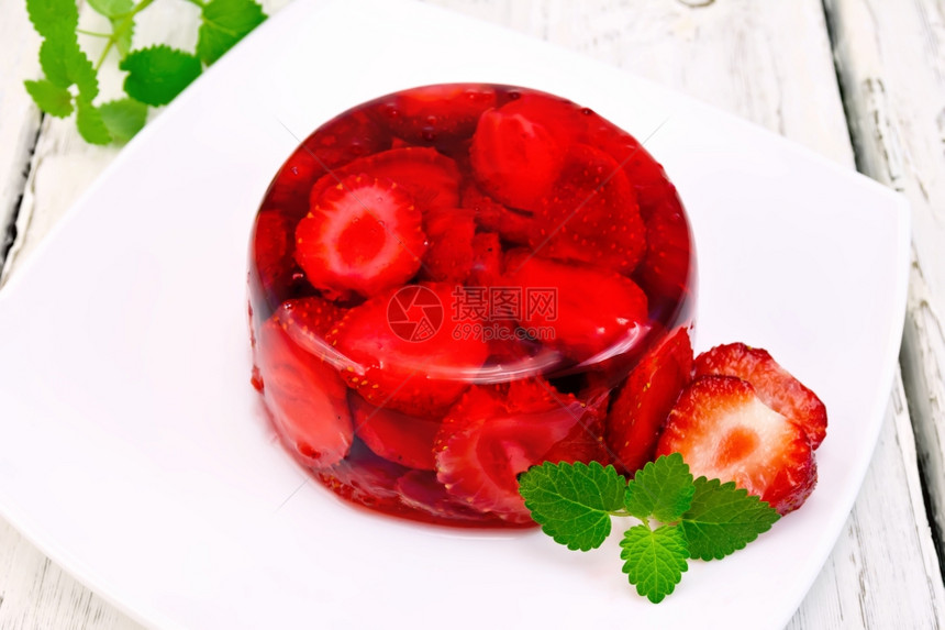 草莓果冻和薄荷浆放在木板底部的厨房毛巾上盘子图片