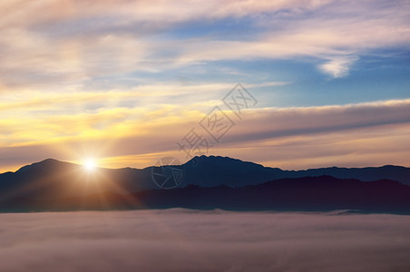 明亮的日出山谷雾地平线上山峰图片