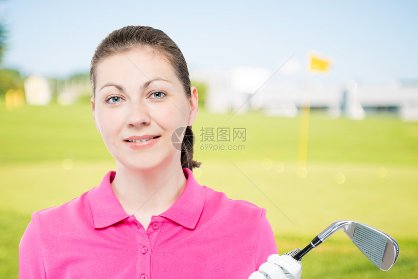 穿粉红马球衬衫的高尔夫俱乐部女孩的横向肖像图片