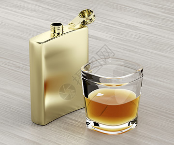 金臀酒瓶和木制桌上一杯威士忌图片