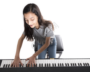 少女在弹奏直立钢琴背景图片
