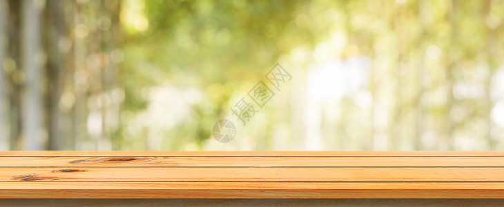 木板空桌底色模糊树林底面的浅色褐木质桌可模拟显示或添加产品春季全景横幅背景图片