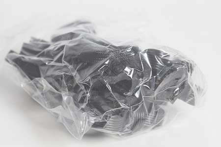 写实带扎绳塑料袋白色塑料袋包装中的电源缆背景