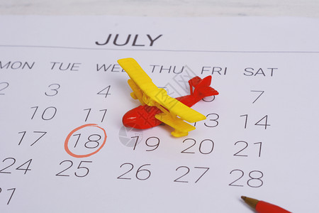 日历表上面的玩具飞机背景