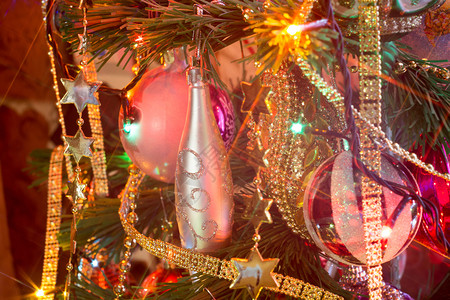 装饰傍晚圣诞节或新年的树上面有装饰灯光和玩具设计图片