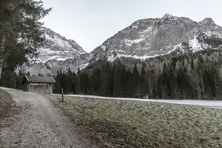 寒冬风景在奥述山丘的中心地带田冰冻的草和雪山图片