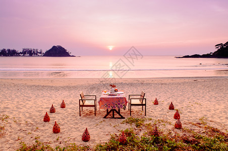 在海滩上浪漫的日落晚宴图片