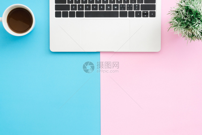 工作空间台的顶层办公桌有笔记本电脑植物和咖啡杯背景为蓝色粉顶层视图有复制空间平面摄影图片
