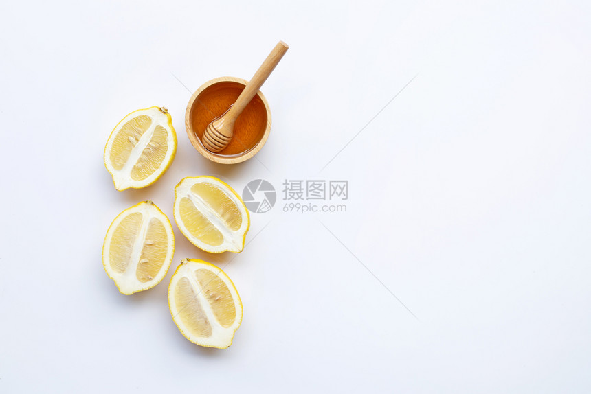 白背景上加柠檬的蜂蜜复制空间图片