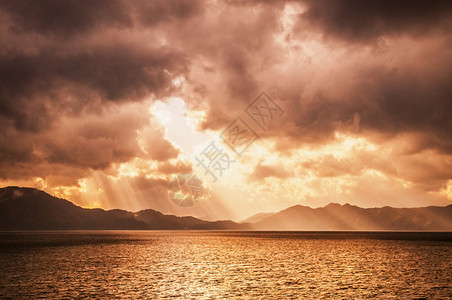 暴风雨前的日落天空与神圣的乌合之众在太泽湖刺骨阿基塔雅潘图片