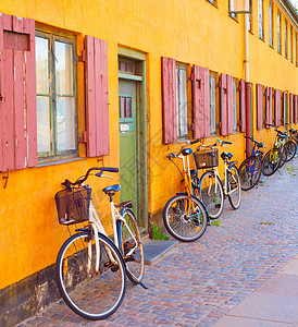 典型丹麦沿旧建筑墙的自行车背景