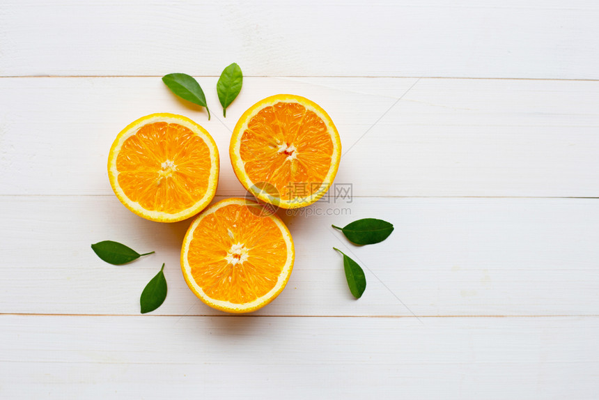 新鲜橙色柑橘水果白木本底有叶子图片