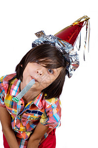 带着口哨的小男孩肖像戴着党帽庆祝的概念图片