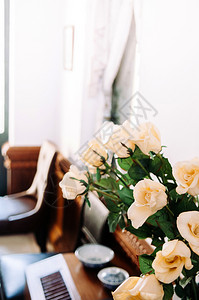 紧拍下美丽的黄玫瑰花束上面有古旧的光彩墙玫瑰花束背景图片